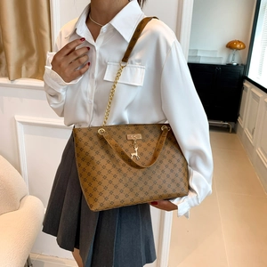 Brown monogram tote bag with gold chain strap and deer pendant for elegant women