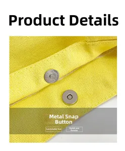 Close-up of dual silver magnetic snap fasteners on thick yellow canvas tote bag