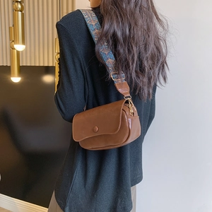 Brown PU saddle bag with blue bohemian wide strap shown on a model for casual style