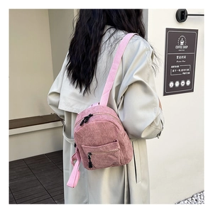 Pink corduroy mini backpack for women showing back view and real-life wearing size