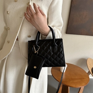 Chic black quilted crossbody bag with matching coin purse and elegant gold chain detail