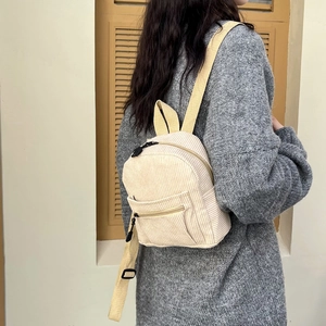 Minimalist beige corduroy backpack for women with front pocket and adjustable straps