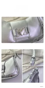Detail of silver metallic shoulder bag with heart buckle and rivet accents