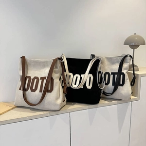 Three canvas tote bags with OOTO embroidery in white, black and brown stylish colors