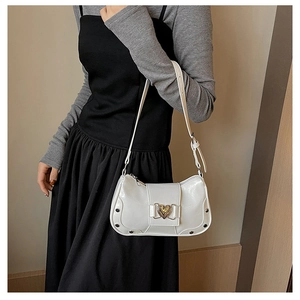 Detail of white glossy underarm bag with heart metal buckle and rivet embellishments