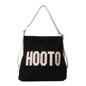Large black canvas tote bag with white HOOTO letter patch and adjustable beige straps