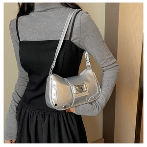 Silver Y2K shoulder bag with heart buckle and metal rivets shown on a model