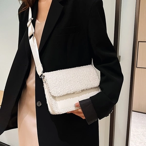 Chic white shearling patchwork square crossbody bag with wide strap on fashion model