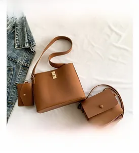 Three-piece brown leather handbag set including a bucket bag and a square crossbody bag