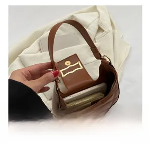 Detailed interior capacity showing space for a phone and wallet in the quilted crescent bag