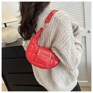 Detailed close-up of a red crescent shoulder bag with quilted leather and golden buckle