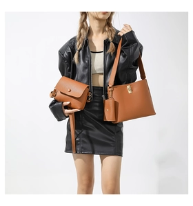 Close-up of three-piece brown leather handbag set including tote and crossbody bag