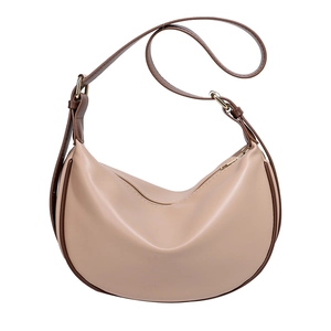 Minimalist beige half-moon crossbody bag with dark brown trim and adjustable strap