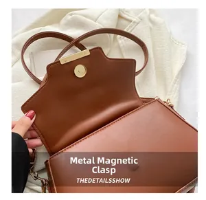 Detail of caramel leather bag showing the golden magnetic snap and the quality closure