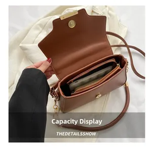 Internal compartments of the brown PU leather crossbody bag showing large storage capacity