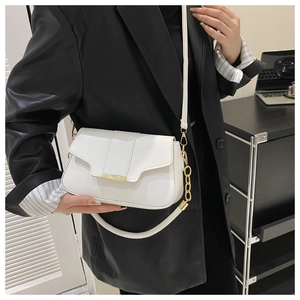 Close-up of white PU leather crossbody bag with gold buckle and chain strap detail