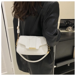 Close-up of white PU leather crossbody bag with golden buckle and adjustable straps