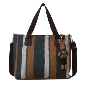 Large striped canvas tote bag in teal and brown with a cute bunny charm pendant