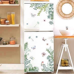 Detail of green plants and colorful butterflies wall decals applied on a white refrigerator