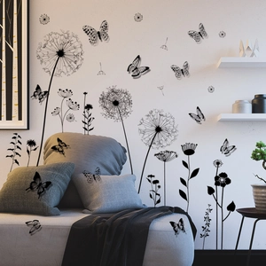 Modern black dandelion and butterfly wall stickers applied over a white sofa in a living room