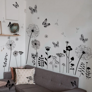Detail of black dandelion wall stickers and 3D butterfly decals in a modern living room