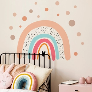 Detailed view of Morandi-colored rainbow and polka dot wall stickers in a cozy nursery
