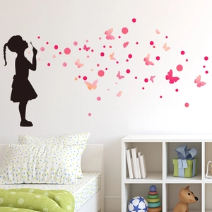 Creative wall decal featuring a girl blowing pink butterflies and bubbles for bedroom decor