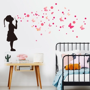 Pink butterflies and girl silhouette wall stickers decorated in a cozy kid's bedroom