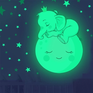 Glow-in-the-dark wall decal featuring a cartoon elephant sleeping on a smiling moon