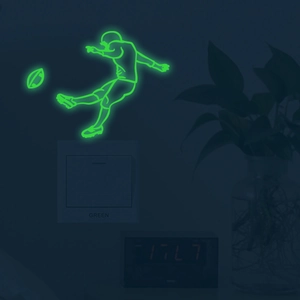 Glow in the dark football player wall sticker showing neon green light over a light switch