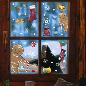 Christmas window stickers with gingerbread man and snowflake patterns on a glass pane