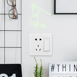 Glow-in-the-dark dunking basketball player sticker applied above a light switch