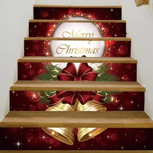 Detail of Christmas stair stickers featuring golden bells and Merry Christmas text