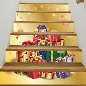 Detailed view of Christmas stair decals with golden holiday gift boxes and snowflakes