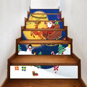 Detailed view of Christmas stair decals featuring Santa Claus and reindeer on wooden stairs