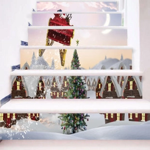 Macro view of Christmas staircase decals showing Santa's sleigh and snowy cabin scene