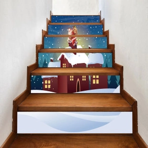 Detailed view of Christmas Santa Claus and snowy house stair riser stickers on wooden stairs