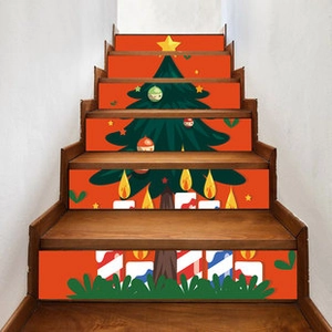 Close-up of festive Christmas tree staircase decals on steps with a bright orange background