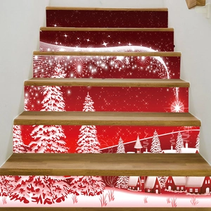 Detail view of festive PVC Christmas staircase stickers with snow and cabins on wooden steps