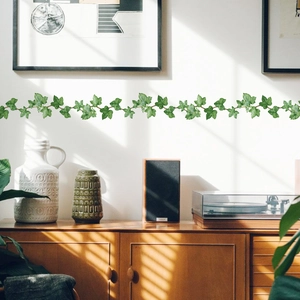 Ivy leaf wall sticker border on a white wall above a vintage walnut wood cabinet