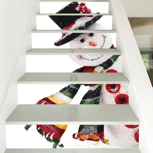 Detail of Christmas snowman stair stickers on white steps featuring festive holiday decor