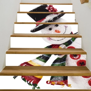 Detailed view of 3D Christmas snowman staircase stickers applied on indoor wooden stairs