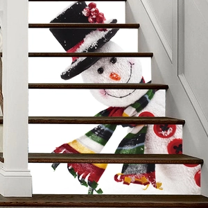 Detailed view of DIY snowman staircase stickers with festive hat and striped scarf