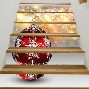 Detail of Christmas stair riser decals with red snowflake ball and gold star patterns