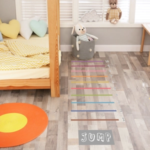 Detailed view of colorful kids long jump floor stickers with numbers 1 to 10 on wood floor