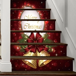 Detail of red Christmas stair stickers featuring golden Merry Christmas text and bells