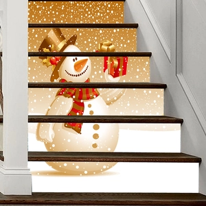 Detailed view of festive snowman stair decals on wood steps with gold snowflake pattern
