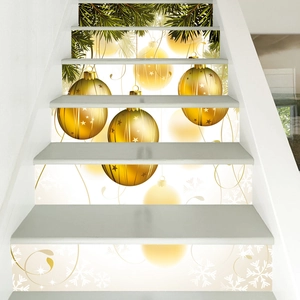 Close-up of golden Christmas ornaments and pine needle decals on indoor stair risers