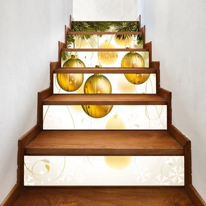 Detailed view of Christmas stair decals with golden bells and green pine branches