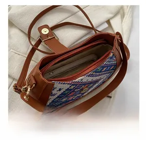Internal view of ethnic crossbody bag showing capacity for a smartphone with woven detail